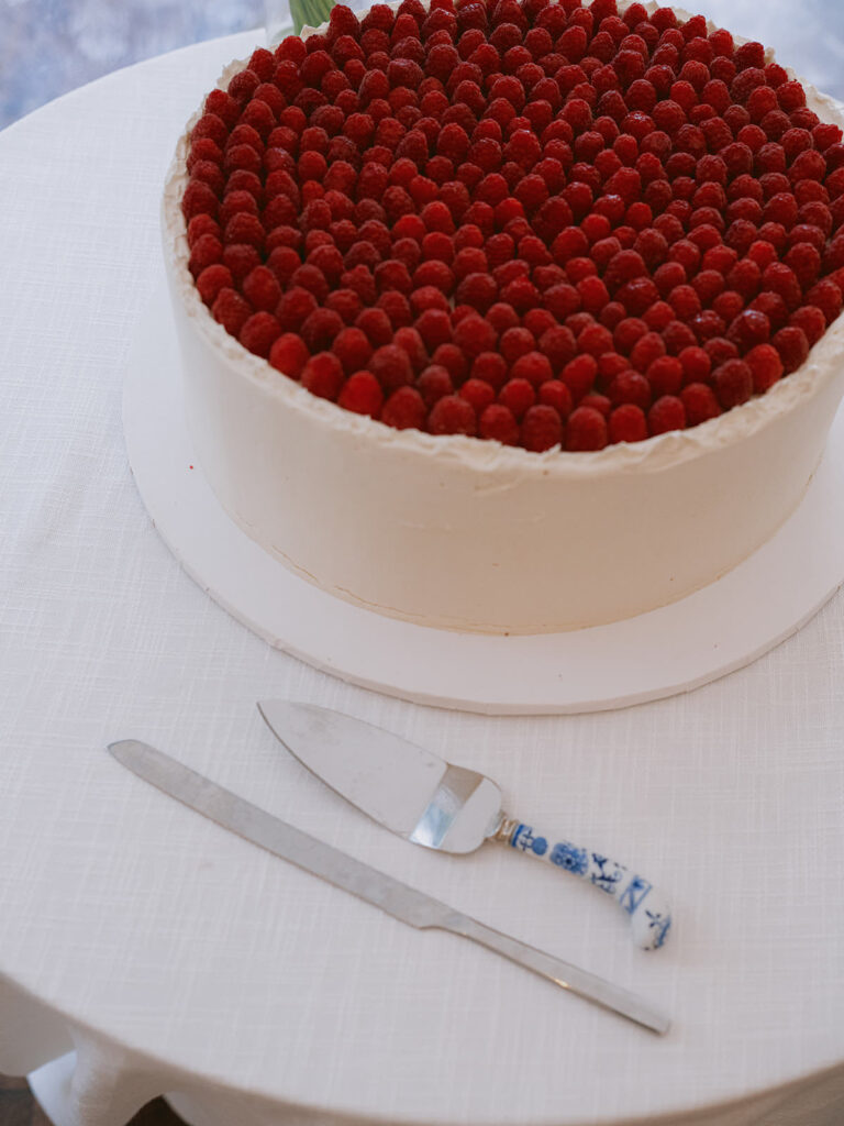 berry topped wedding cake on display