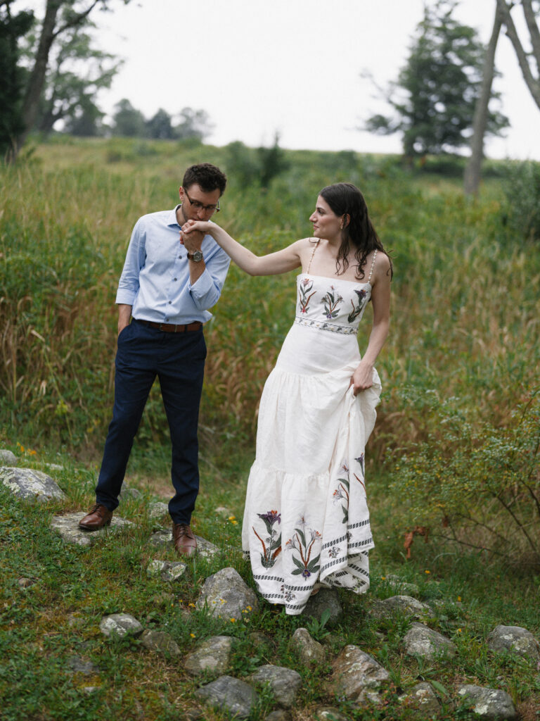 groom kisses brides hand