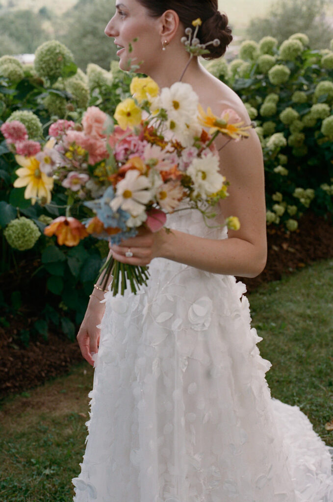 Bride holding colorful bouquet of wildflowers