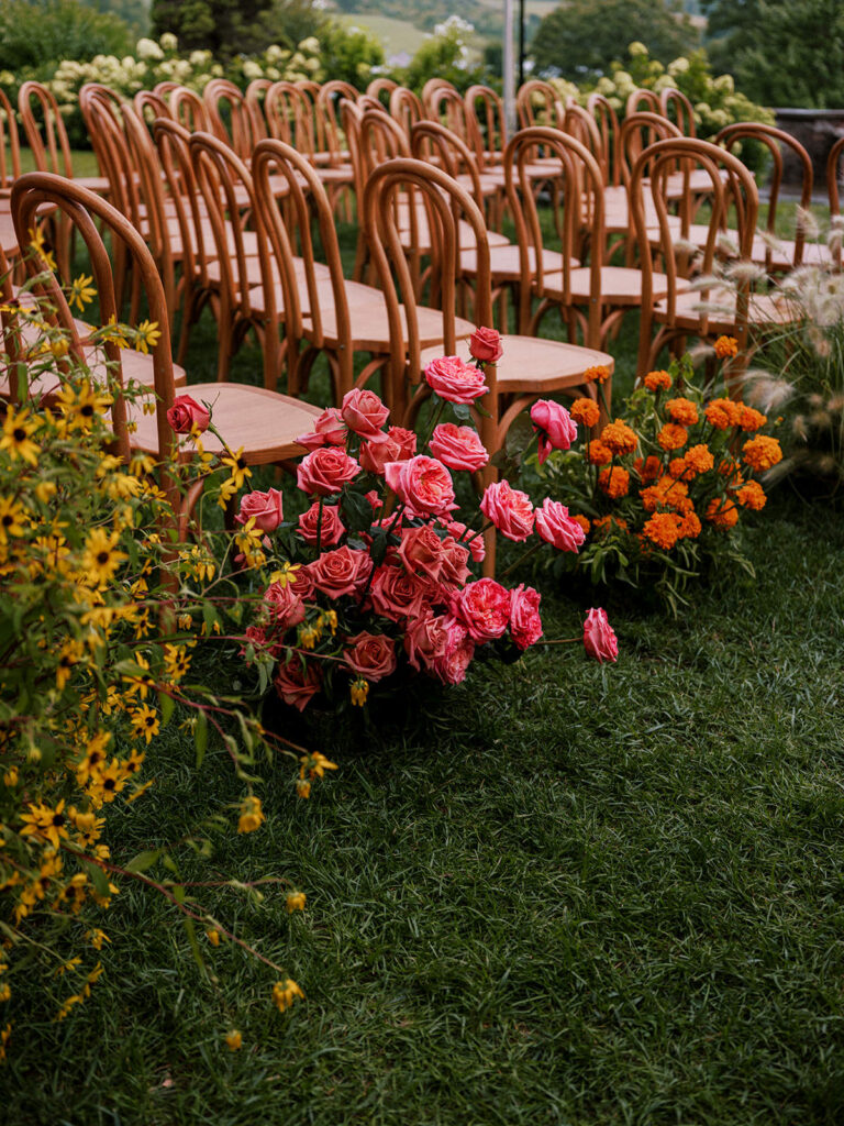 Colorful flowers down a wedding aisle at Glynwood Farm