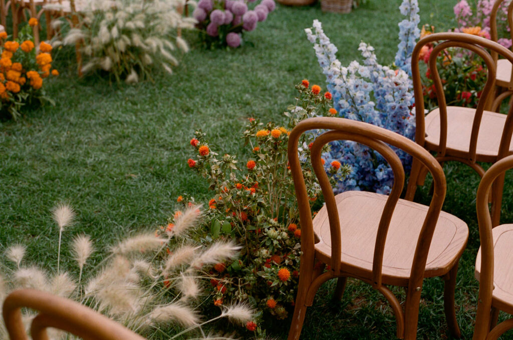 Colorful flowers down a wedding aisle